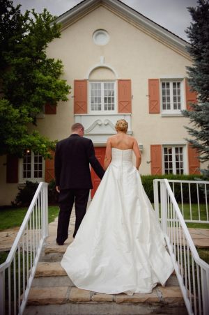 Bride and groom on steps ~ Photo by Dezember Photography